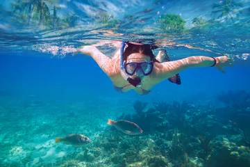 Foto auf Glas Beautiful women snorkeling in the tropical sea © Patryk Kosmider