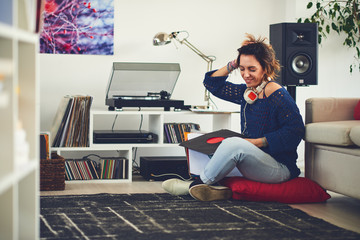 Woman listening vinyl at home