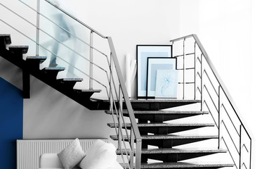 Modern stairs in office and blurred silhouettes of moving people