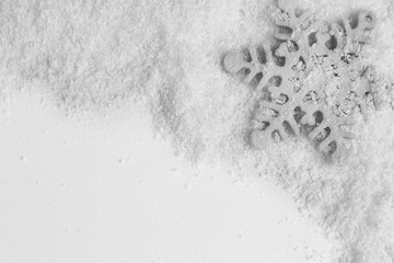 Snowflake on snowy background, close up