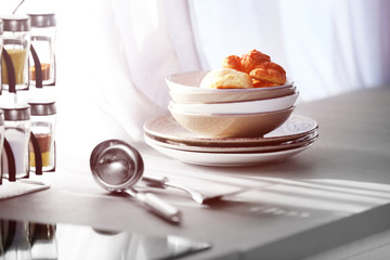 Utensils and croissants on kitchen table beside the window