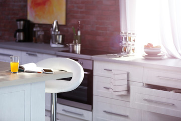 Modern kitchen interior with white furniture and electric stove