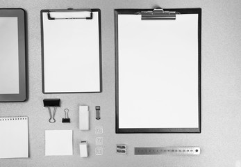 Fototapeta na wymiar Office set with white sheets of paper, tablet and stationery on grey background