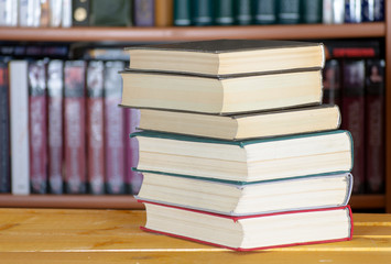 Several books in front of a bookcase