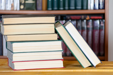 Several books in front of a bookcase