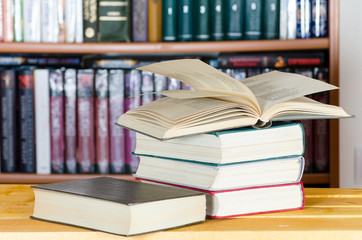 Several books in front of a bookcase