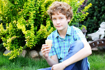 Naklejka na ściany i meble teenager boy is eating his ice cream.