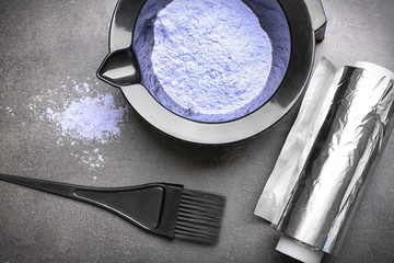 Barber set with hair dye, foil and brush on grey background