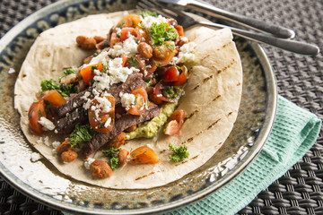 Beef burrito with feta, refried beans & chill greens 