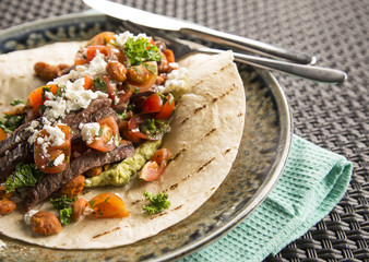 Beef burrito with feta, refried beans & chill greens 