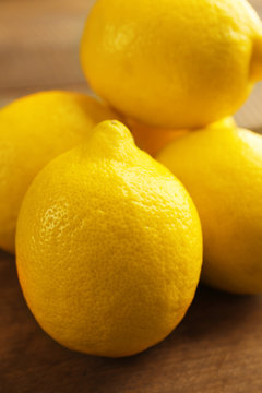 Fresh lemons on wooden table closeup