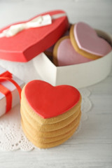 Valentine heart cookies in present box on wooden table closeup