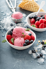 Raspberry ice cream in white bowl