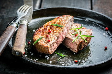 Hot grilled meat with fresh herbs on plate