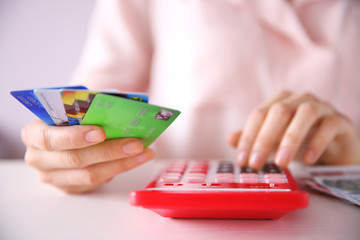 Female calculate with credit card and euro money, closeup