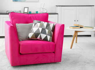 Pink armchair in modern interior of living room