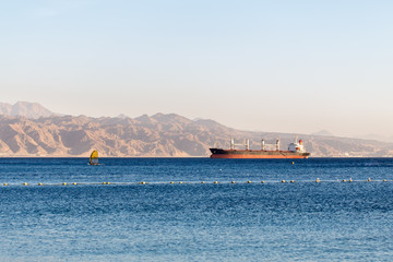 Cargo ship wind surfing vessel Red sea Israel. © subbotsky