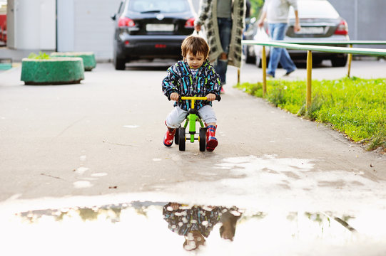 Cute baby boy learning to ride bike