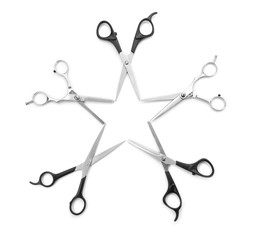 A star created within blades of five  professional scissors isolated on white background