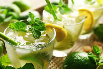 Mojito drink with lime, lemon and mint, closeup