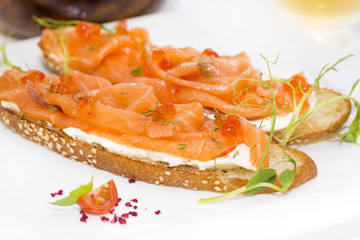 sandwiches with salmon caviar and greens adorned