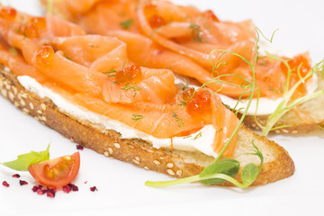 sandwiches with salmon caviar and greens adorned