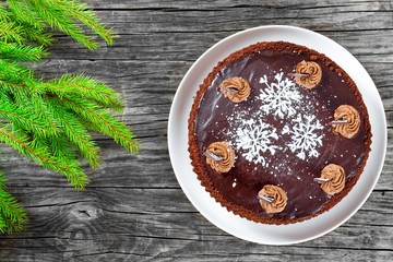 chocolate cake decorated with chocolate chips and icing-sugar snowflake, close-up