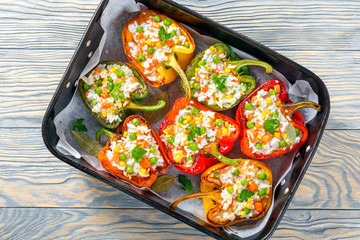 bell pepper stuffed with rice, green peas, carrots, top view