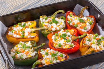 bell pepper stuffed with rice, green peas, carrots, top view