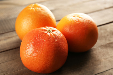 Grapefruits on wooden background, close up