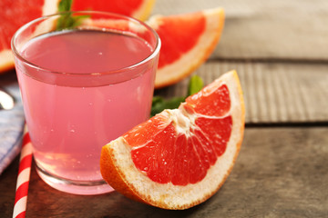 Ripe grapefruits and fresh juice with mint, close up