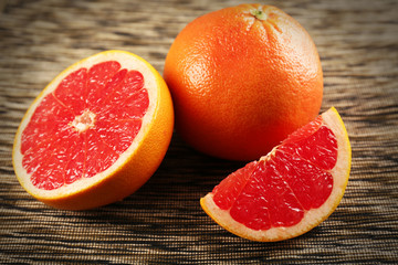 Juicy grapefruits on stripped napkin, close up