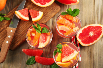 Ripe grapefruits and fresh juice with mint, close up