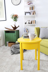 Interior of living room with yellow table