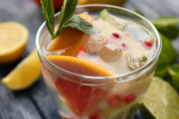 Refreshing cocktail with ice, mint, pomegranate seeds and slices of fruits