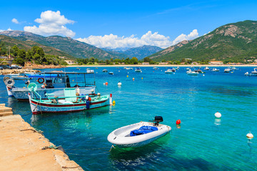 Typical fishing boats in small port on coast of southern Corsica island near Cargese town