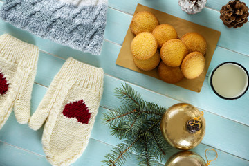 Christmas composition with cookies, mittens and decorations on a blue table