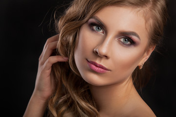 Fototapeta premium Beauty model girl with perfect make-up isolated over white. Portrait of attractive young woman with blond hair on white background. Beautiful female face with clear fresh skin