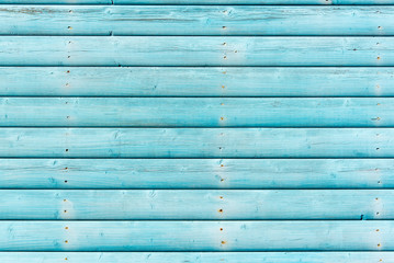 Section of weathered turquoise blue panelling from a beach hut, suitable for backgrounds of beach,...