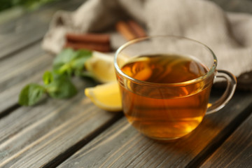 Cup of tea with mint on wooden table