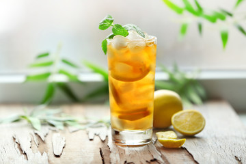 Glass of iced tea with lemon on a windowsill