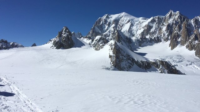 Ski mountaineers walking on a glacier in the Mont Blanc Massif, Chamonix, France, Europe. 4K UHD