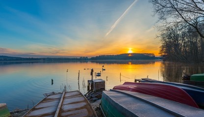 Obraz premium Lake shore with fisherman's boats in colorful landscape