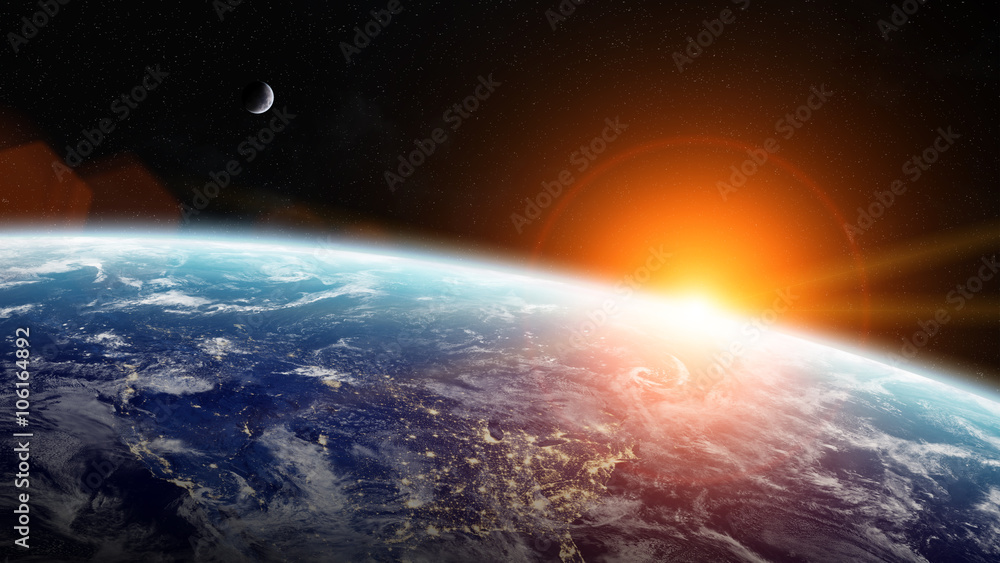 Wall mural sunrise over planet earth in space