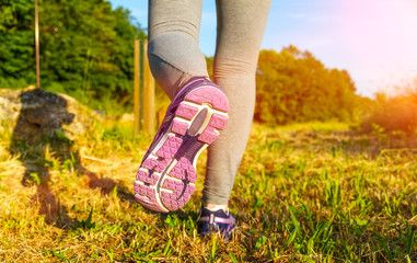 Woman running at sunset in a field
