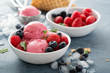 Raspberry ice cream in white bowl
