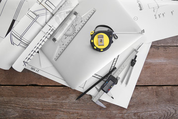 Laptop and blueprints on a white background.
