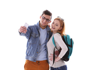 Young couple taking selfie with mobile phone isolated on white