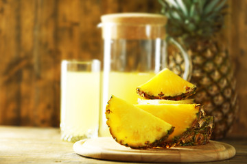 Juicy pineapple slices on wooden cutting board, close up