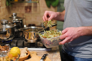 man prepares herbal tea